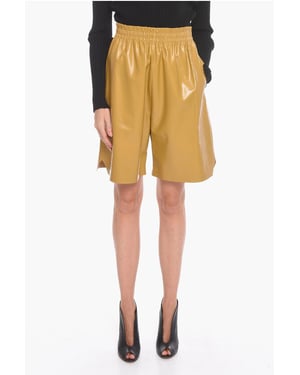 GLANZENDE Gaucho-shorts van leer in geel
