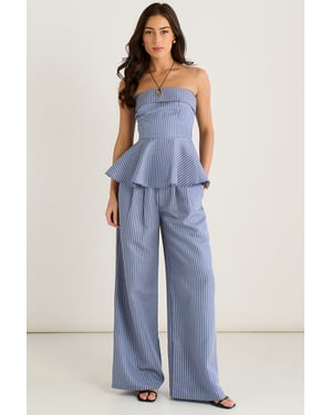 Blauwe peplumtop met Bardot-strepen