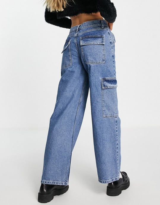 ASOS DESIGN cotton blend low rise 'cargo' jean in mid wash blue