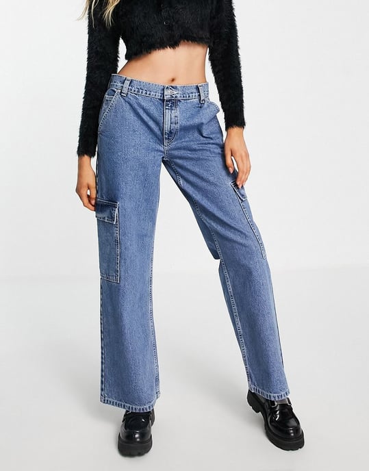 ASOS DESIGN cotton blend low rise 'cargo' jean in mid wash blue