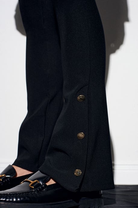 Hoog-getailleerde flare leggings met knoopdetail - Image 1