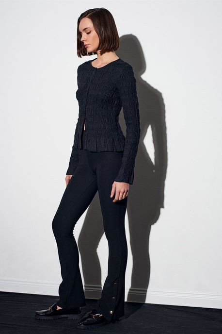 Hoog-getailleerde flare leggings met knoopdetail - Image 2