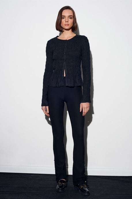 Hoog-getailleerde flare leggings met knoopdetail - Image 5